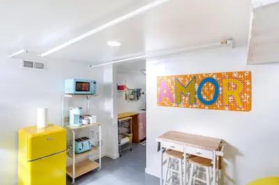 a kitchen with a yellow refrigerator and a table at Gordon Square Studio about 4 Mi to Downtown Cleveland! in Cleveland