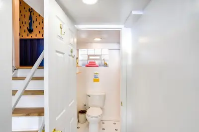 a bathroom with a toilet and a staircase at Gordon Square Studio about 4 Mi to Downtown Cleveland! in Cleveland
