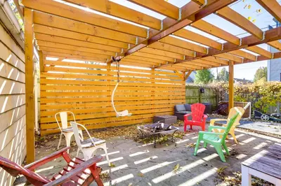 a patio with chairs and a wooden pergola at Gordon Square Studio about 4 Mi to Downtown Cleveland! in Cleveland