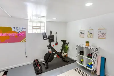 a room with a gym with a elliptical machine at Gordon Square Studio about 4 Mi to Downtown Cleveland! in Cleveland