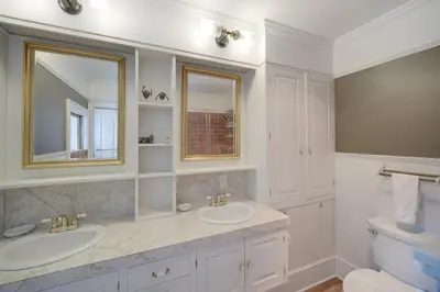 a white bathroom with two sinks and a mirror at Peninsula Paradise - Walk to Hiking and Shopping! in Peninsula