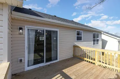 a home with a large glass door on a deck at Home among the Nook in Hamilton Ohio in Hamilton