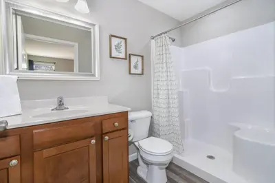 a bathroom with a toilet and a sink and a mirror at Home among the Nook in Hamilton Ohio in Hamilton