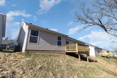 a house with a porch and a deck on a hill at Home among the Nook in Hamilton Ohio in Hamilton