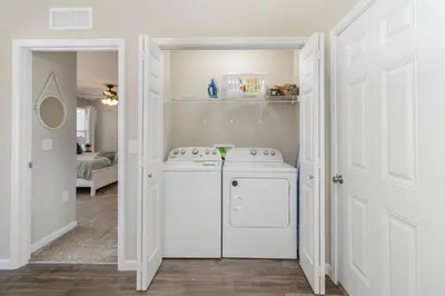 a white laundry room with a washer and dryer at Brand NEW home among the Nook in Hamilton, Ohio in Hamilton
