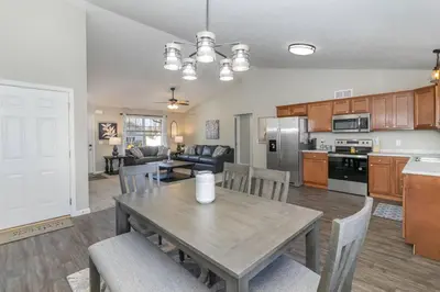 a kitchen and living room with a table and chairs at Brand NEW home among the Nook in Hamilton, Ohio in Hamilton