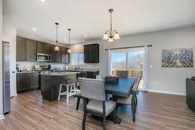 a kitchen and dining room with a table and chairs at Cheerful 5 bedroom on azra with a pool and real in Morrow