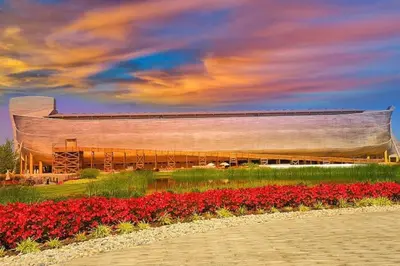 a large building with red flowers in front of it at Cheerful 5 bedroom on azra with a pool and real in Morrow