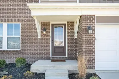 a brick house with a brown door and a doorstep at Cheerful 5 bedroom on azra with a pool and real in Morrow