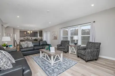 a living room with a couch and chairs and a table at Brand new construction in well-kept HOA community in Mason