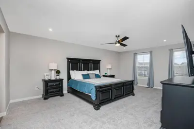 a bedroom with a bed and a ceiling fan at Brand new construction in well-kept HOA community in Mason
