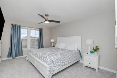 a bedroom with a bed and a ceiling fan at Brand new construction in well-kept HOA community in Mason