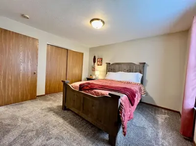 a bedroom with a large bed with a wooden headboard at Cozy 2 Bedroom Paired Home in Middletown, OH in Middletown