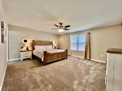 a bedroom with a bed and a ceiling fan at Peaceful, Brand New Ranch Home in Trenton, OH in Trenton