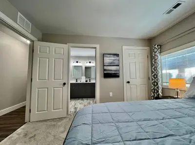 a bedroom with a large bed and a bathroom at Quaint 4 Bedroom Ranch Home in Mason Ohio in Mason