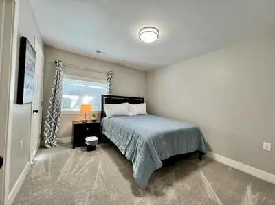 a bedroom with a bed and a window at Quaint 4 Bedroom Ranch Home in Mason Ohio in Mason