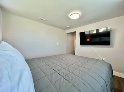 a bedroom with a bed and a flat screen tv at Quaint 4 Bedroom Ranch Home in Mason Ohio in Mason