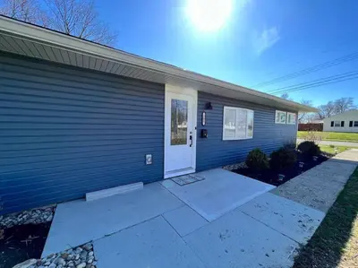 a blue house with a white door at Quaint 4 Bedroom Ranch Home in Mason Ohio in Mason