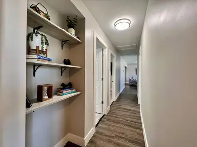 a hallway with shelves on the wall and a hallway with a hallway at Quaint 4 Bedroom Ranch Home in Mason Ohio in Mason
