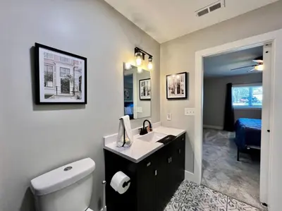 a bathroom with a sink and a toilet and a bedroom at Quaint 4 Bedroom Ranch Home in Mason Ohio in Mason