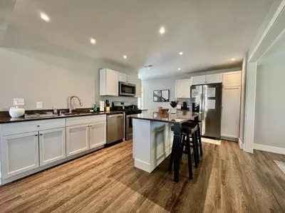 a kitchen with white cabinets and a table in it at Quaint 4 Bedroom Ranch Home in Mason Ohio in Mason