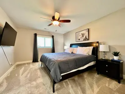 a bedroom with a bed and a ceiling fan at Quaint 4 Bedroom Ranch Home in Mason Ohio in Mason