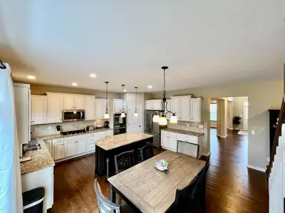 a kitchen with a wooden table and a dining room at Exclusive Golf Club Paradise in Lebanon