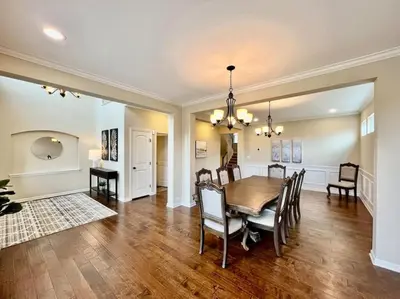 a dining room and living room with a table and chairs at Exclusive Golf Club Paradise in Lebanon