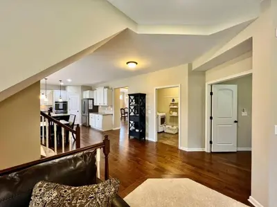a living room with a couch and a kitchen at Exclusive Golf Club Paradise in Lebanon