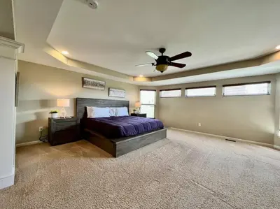 a bedroom with a bed and a ceiling fan at Exclusive Golf Club Paradise in Lebanon