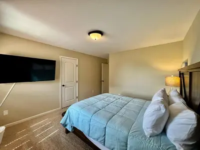 a bedroom with a bed and a flat screen tv at Exclusive Golf Club Paradise in Lebanon