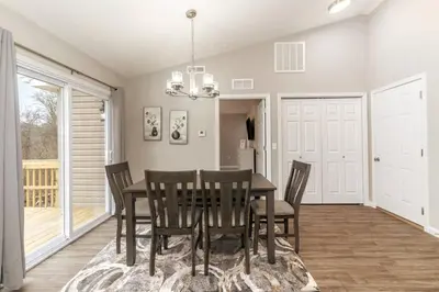 a dining room with a table and chairs at Beautiful NEW Home among the Nook in Hamilton, OH in Hamilton