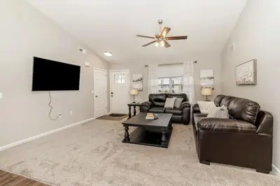 a living room with a couch and a flat screen tv at Beautiful NEW Home among the Nook in Hamilton, OH in Hamilton