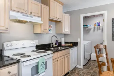 a kitchen with a white stove and a sink at Relaxing home near Interstate in Monroe
