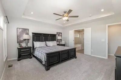 a bedroom with a bed and a ceiling fan at Cul de sac home in Family friendly community in Maineville