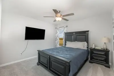 a bedroom with a bed and a ceiling fan at Cul de sac home in Family friendly community in Maineville