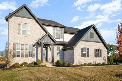 a large brick house with a black roof at Cul de sac home in Family friendly community in Maineville