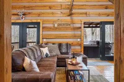 a living room with a couch and a table at Deerview Cabin by Wanderlust Properties in Logan