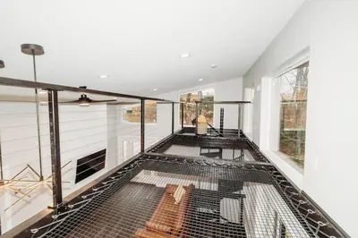 a room with a large cage on the floor at Luxury Cliffside Hammock House in Wellington
