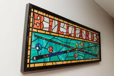 a stained glass window with the word autism on it at Luxury Cliffside Hammock House in Wellington