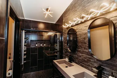 a bathroom with a sink and a mirror at Luxury Cliffside Hammock House in Wellington