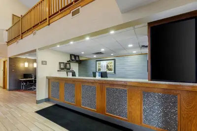 a lobby with a large flat screen tv at Best Western Falcon Plaza - Bowling Green in Bowling Green