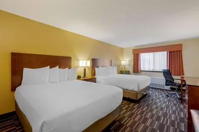 a hotel room with two beds and a window at Best Western Falcon Plaza - Bowling Green in Bowling Green