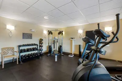 a room with a gym with a treadmill and weights at Best Western Falcon Plaza - Bowling Green in Bowling Green