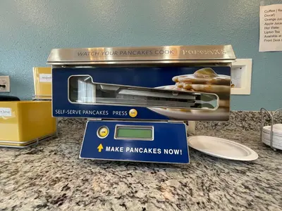 a toaster on a counter with a sign in front of it at Days Inn by Wyndham Batavia Ohio in Batavia