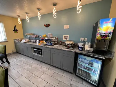 a kitchen with a counter with a refrigerator at Days Inn by Wyndham Batavia Ohio in Batavia