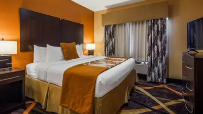 a hotel room with a large bed and a television at Best Western Plus Whitewater Inn in Harrison