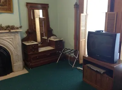 a living room with a tv and a mirror at Inn Port D'Vino in Dayton