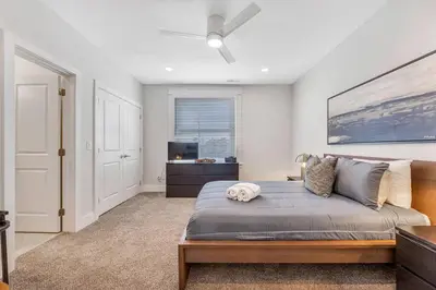 a bedroom with a large bed and a television at 3 Bdrm 3 Full Bath Tower View walk up in Cincinnati