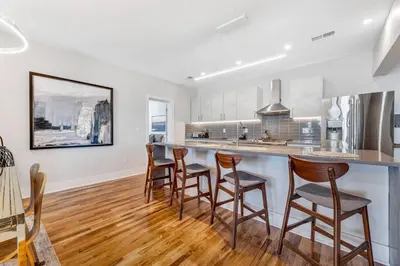 a kitchen with a bar with stools in it at 3 Bdrm 3 Full Bath Tower View walk up in Cincinnati